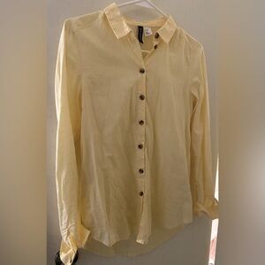Yellow button down long sleeve shirt.